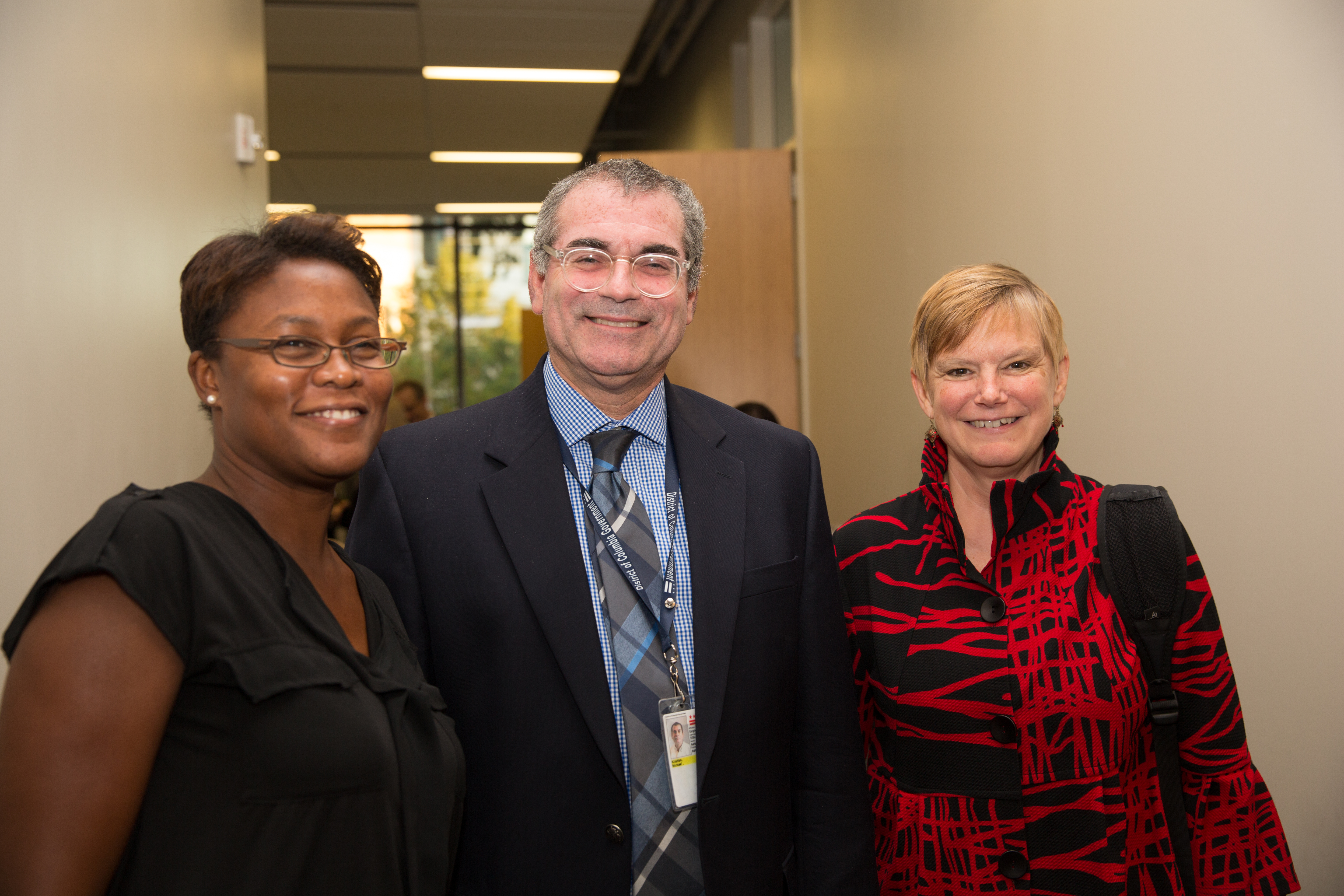 Three DC CFAR Investigators smile at the camera
