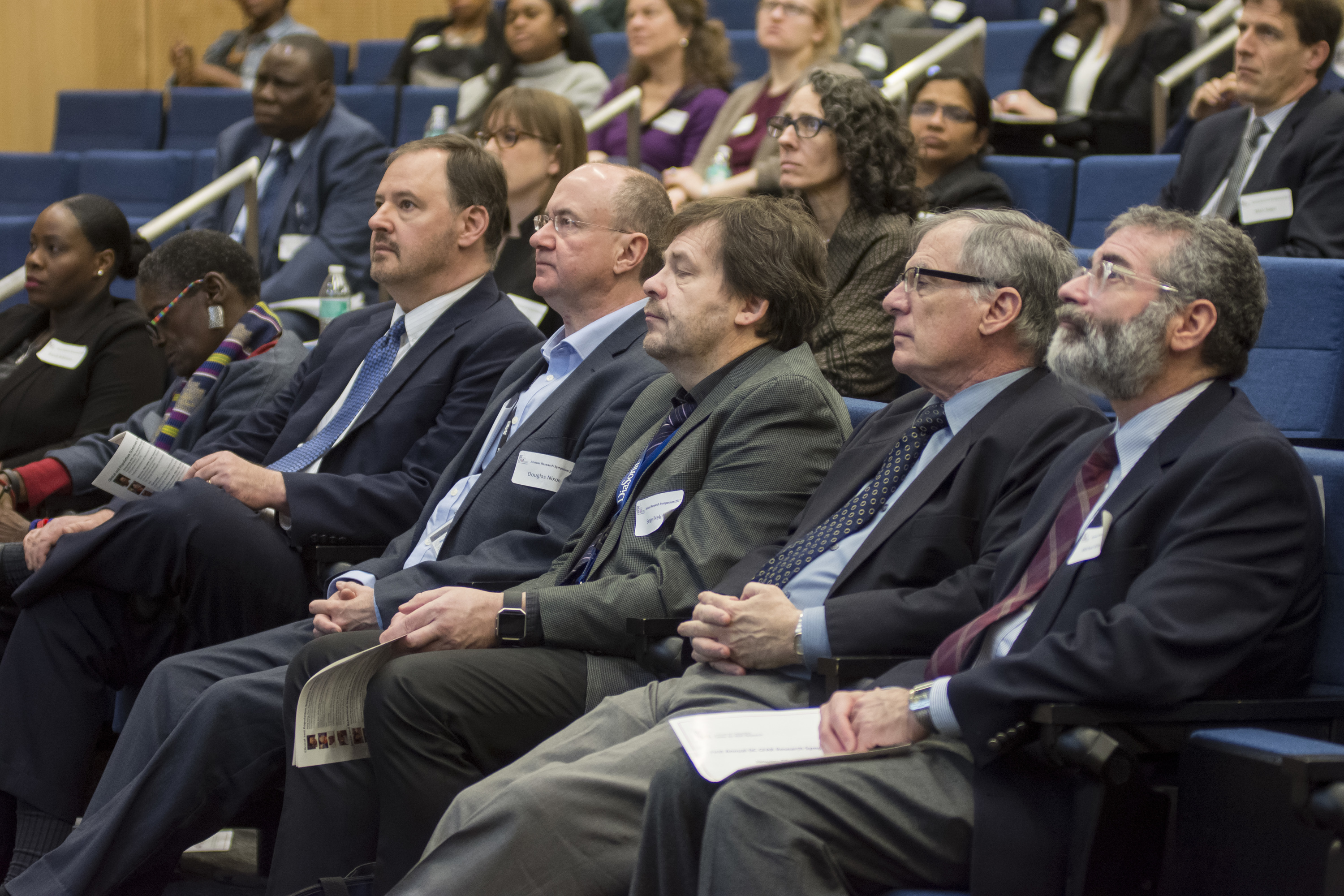 CFAR leadership sit in the front row and listen to speakers 