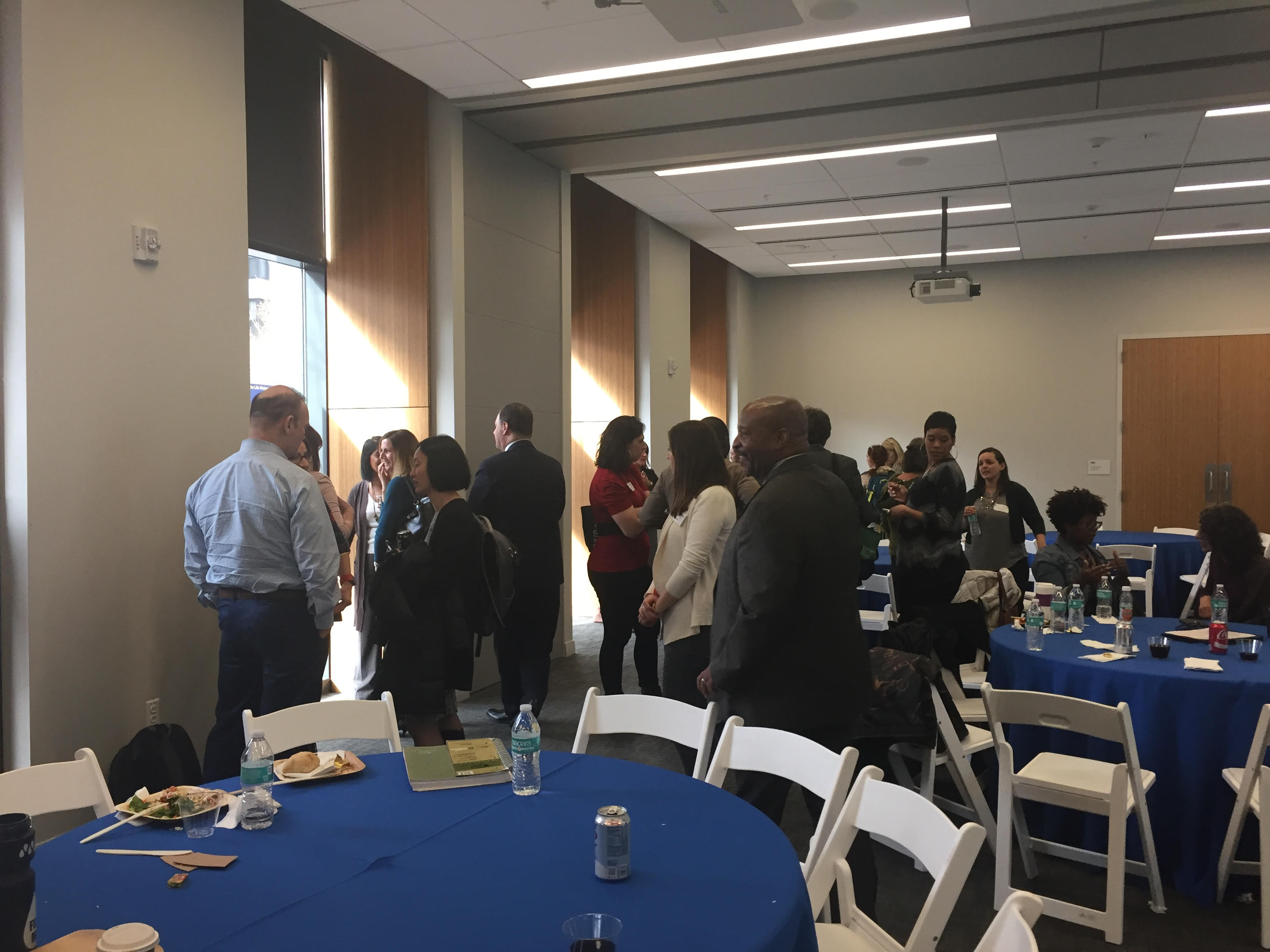 Guests interact around the conference room at the Annual Research Day 2018