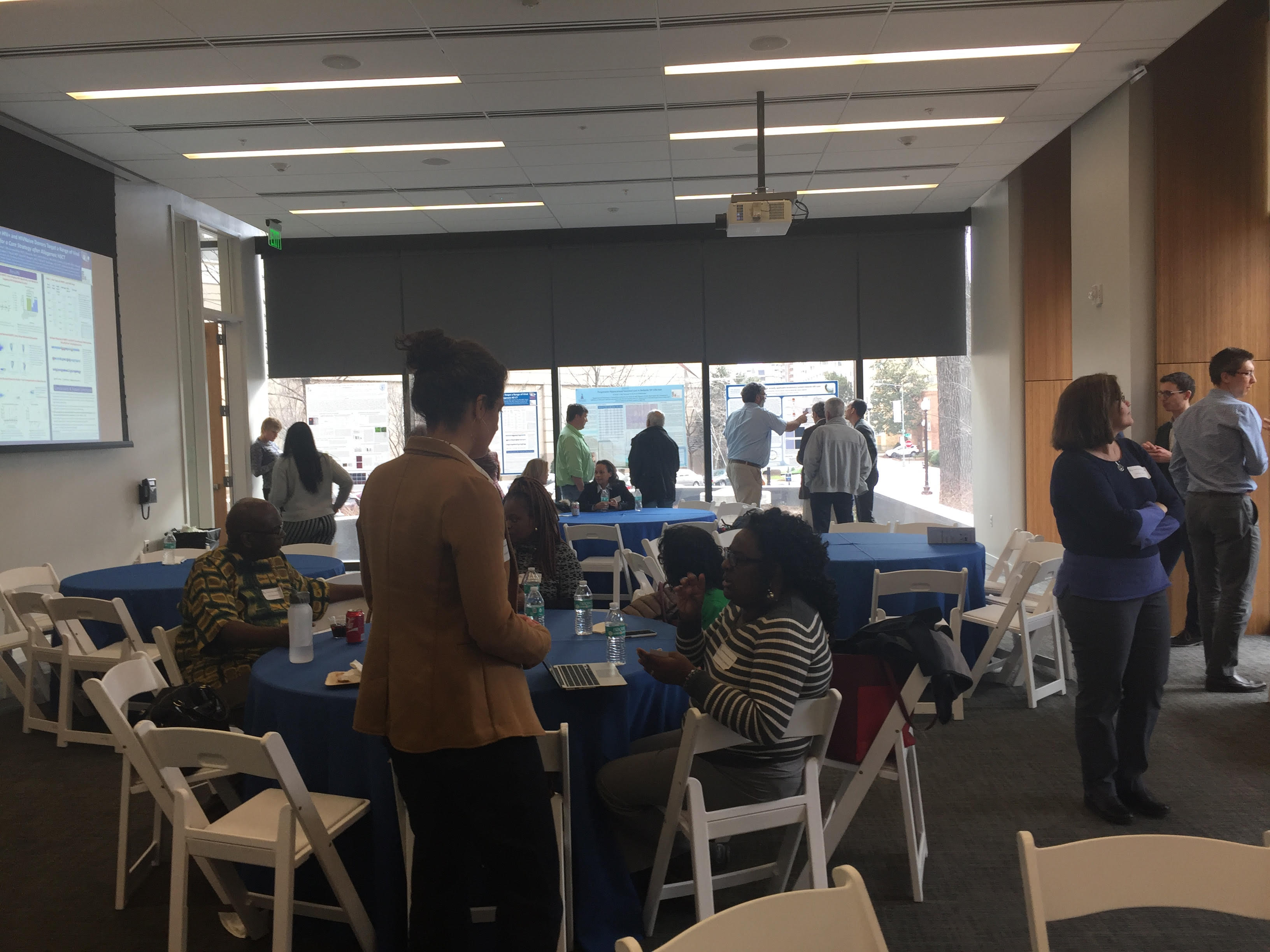 Two guests interact at the Annual Research Day 2018